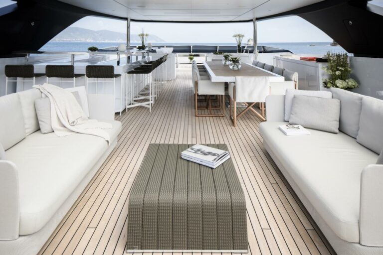 Flybridge luxury yacht SEVEN SINS spacious deck for charter loung and dining white and grey design